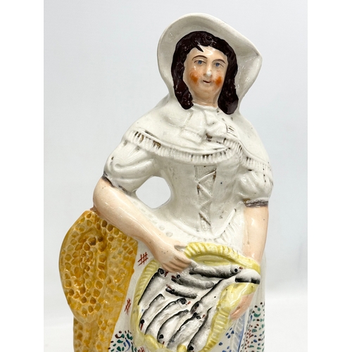 136 - A 19th Century Victorian Staffordshire Pottery “Fishmonger” figurine. Circa 1860-1870. 33.5cm.