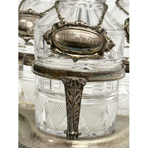 77 - A 19th Century Victorian 3 glass decanter set on stand. With 3 rings and silver plated labels. Whisk... 