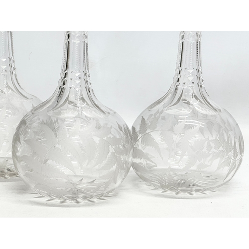 76 - A set of 4 matching Late 19th Century Victorian glass decanters, with notch cut and etched fern desi... 