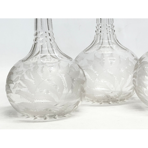 76 - A set of 4 matching Late 19th Century Victorian glass decanters, with notch cut and etched fern desi... 