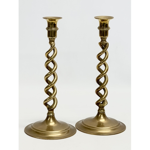 520 - A pair of large Early 20th Century brass candlesticks with barely twist columns. 29cm.