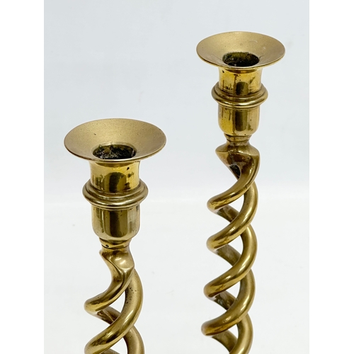 520 - A pair of large Early 20th Century brass candlesticks with barely twist columns. 29cm.