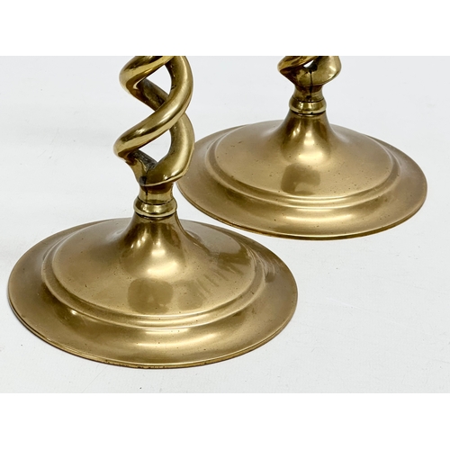 520 - A pair of large Early 20th Century brass candlesticks with barely twist columns. 29cm.