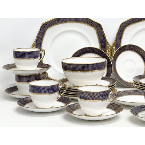 240 - Royal Albert. A 1920’s 36 piece Royal Albert gilt and cobalt blue crown china tea service.