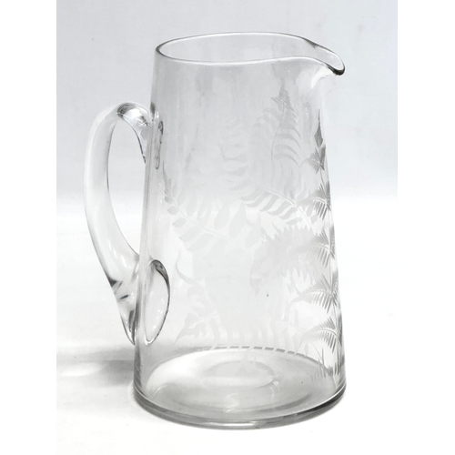 148 - A Late 19th Century Victorian etched glass water jug. Circa 1890-1900. 16x21cm.