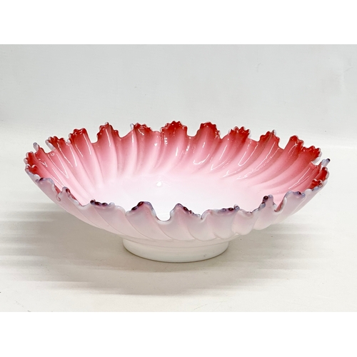 108 - A large Late 19th/Early 20th Century cranberry and milk glass centrepiece bowl, with ruffled rim. Ci... 