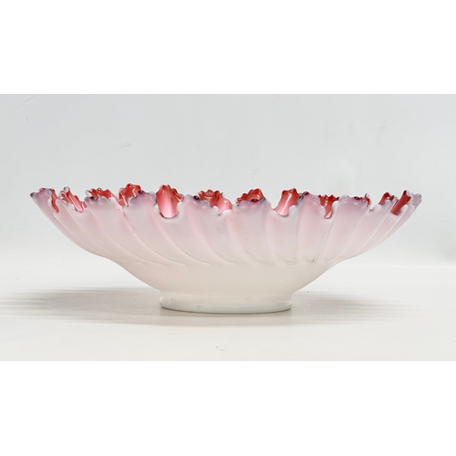 108 - A large Late 19th/Early 20th Century cranberry and milk glass centrepiece bowl, with ruffled rim. Ci... 