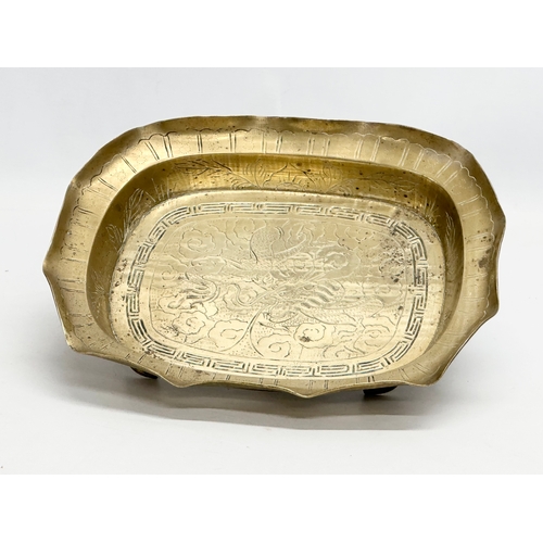 197 - A Late 19th/Early 20th Century Chinese engraved brass bowl. With a flared rim, raised on 4 feet. 29.... 