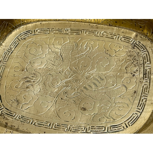 197 - A Late 19th/Early 20th Century Chinese engraved brass bowl. With a flared rim, raised on 4 feet. 29.... 