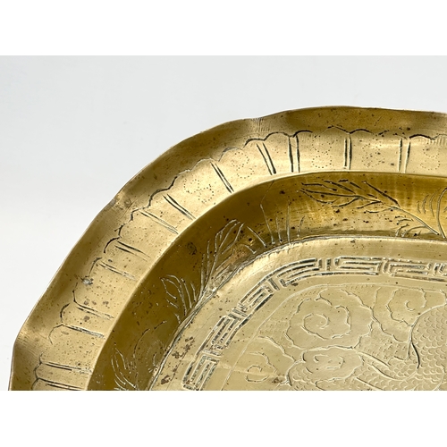 197 - A Late 19th/Early 20th Century Chinese engraved brass bowl. With a flared rim, raised on 4 feet. 29.... 