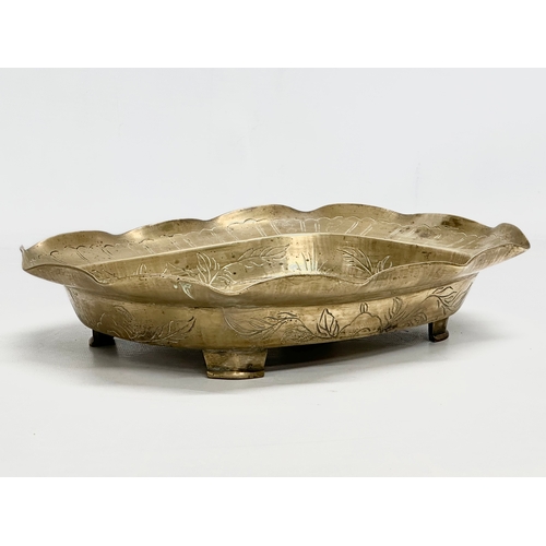 197 - A Late 19th/Early 20th Century Chinese engraved brass bowl. With a flared rim, raised on 4 feet. 29.... 