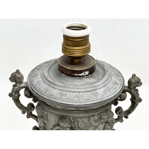 198 - A Late 19th Century pewter urn with cover. Converted into a lamp. With dancing cherub putti relief. ... 