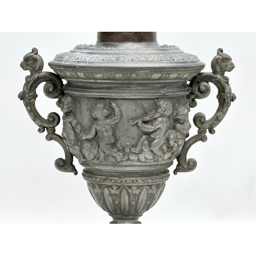 198 - A Late 19th Century pewter urn with cover. Converted into a lamp. With dancing cherub putti relief. ... 