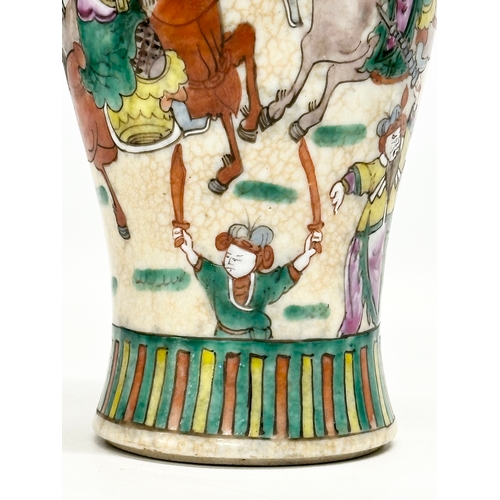 101 - A Late 19th Century Chinese crackled glazed Nanjing vase. Decorated with battle scene warriors. 26cm