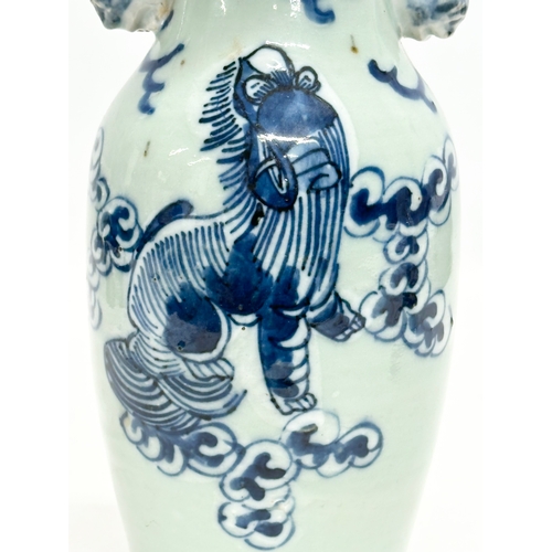 102 - A 19th Century Chinese celadon glazed baluster vase, with blue foo dog and brass rim. 24.5cm.