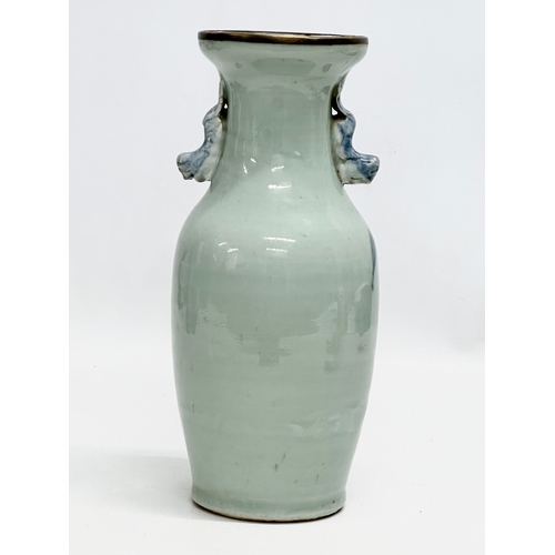 102 - A 19th Century Chinese celadon glazed baluster vase, with blue foo dog and brass rim. 24.5cm.