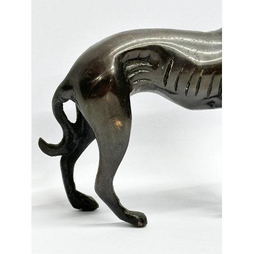 219 - A bronze whippet. 15x13cm.