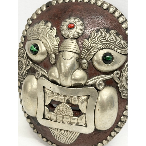 264 - A Tibetan wall mask. 18x22.5cm