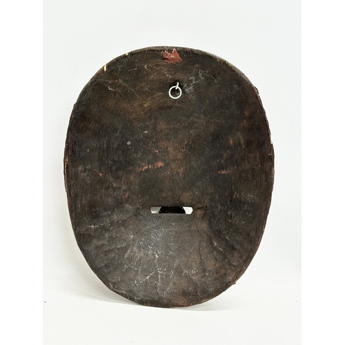 264 - A Tibetan wall mask. 18x22.5cm