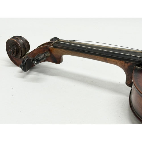 177 - A 19th/Early 20th Century violin and bow. 60cm