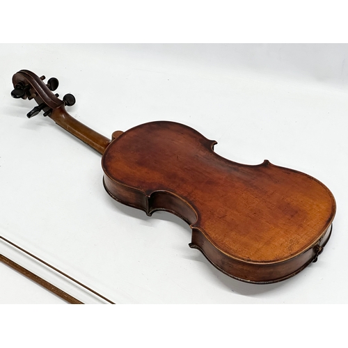 177 - A 19th/Early 20th Century violin and bow. 60cm