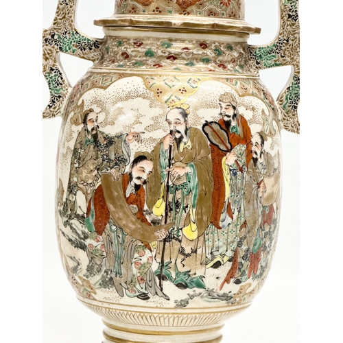 53 - An Early 20th Century Japanese hand painted 2 handled vase with cover. With immortals and foo dog de... 