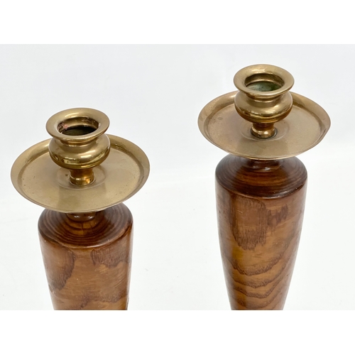 300 - A pair of Early 20th Century brass top candlesticks. 26cm