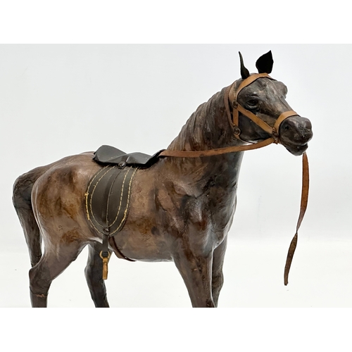 274 - A large vintage leather horse. 36x46cm