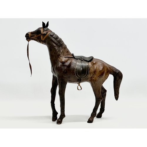 274 - A large vintage leather horse. 36x46cm