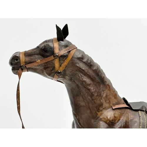 274 - A large vintage leather horse. 36x46cm