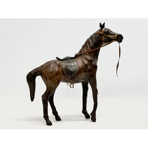 274 - A large vintage leather horse. 36x46cm