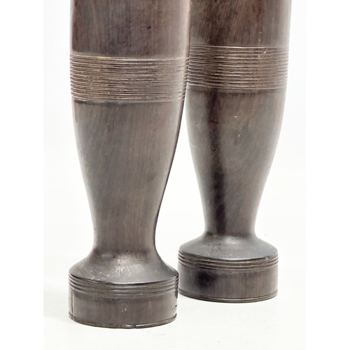 371 - A pair of Late 19th Century turned coromandel wood vases. 18cm