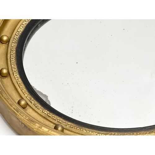 256 - A Late 19th Century Regency style gilt framed mirror. 47cm