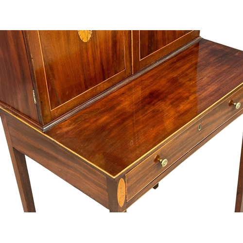 16 - A George III Sheraton style inlaid mahogany side cabinet/desk. Circa 1800. 68.5x48x129cm(1)