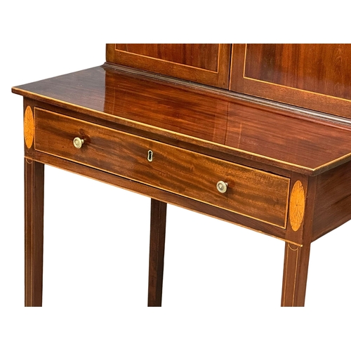 16 - A George III Sheraton style inlaid mahogany side cabinet/desk. Circa 1800. 68.5x48x129cm(1)