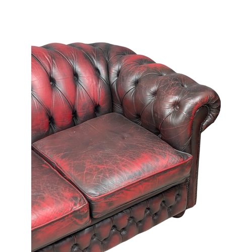 160 - A 3 seater ox-blood leather deep button back Chesterfield sofa / coach. 195cm (1)