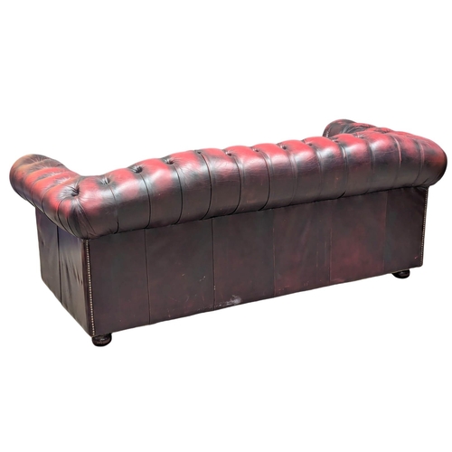 160 - A 3 seater ox-blood leather deep button back Chesterfield sofa / coach. 195cm (1)