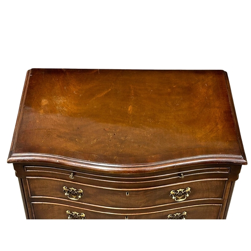 261 - A 1930’s Chippendale style mahogany serpentine front bachelors chest of drawers. 66x43x77cm (8)