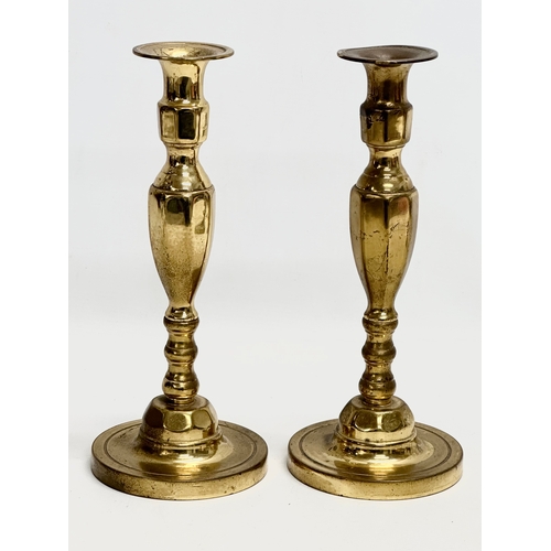 994 - Three pairs of brass candlesticks. 27cm. 15cm. 10cm.