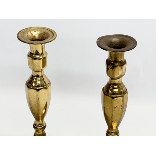 994 - Three pairs of brass candlesticks. 27cm. 15cm. 10cm.