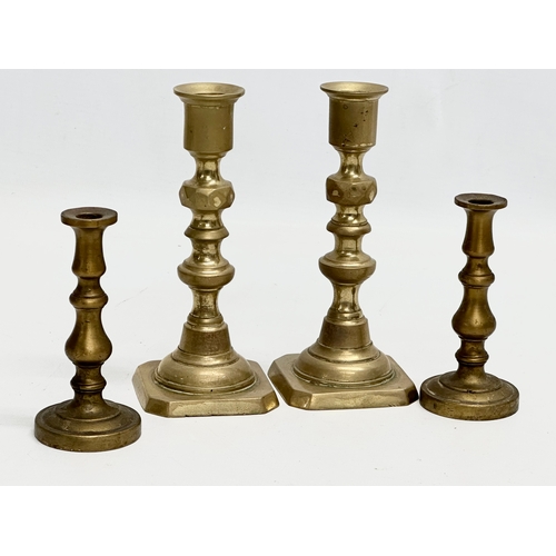 994 - Three pairs of brass candlesticks. 27cm. 15cm. 10cm.