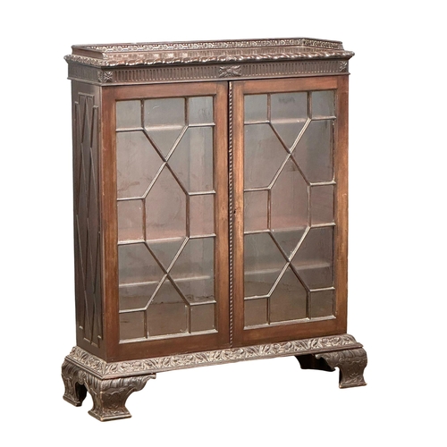 462 - An early 20th century Chippendale Revival mahogany bookcase with astragal doors and carved Ogee Feet... 