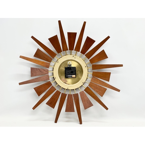 200 - Anstey & Wilson. A 1960’s Mid Century teak sunburst clock. 55x55cm