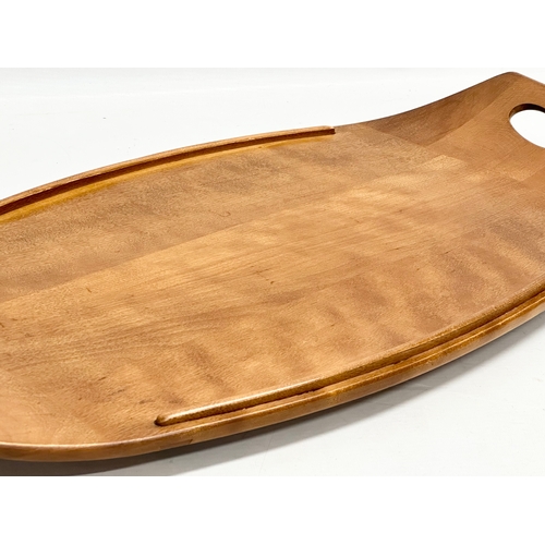 223 - A Mid Century maple tray. By Baribocraft. In the manner of Jens Quistgaard. 61x31cm.