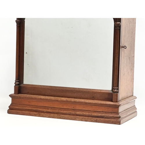 411 - A 19th Century Victorian oak Gothic style tabletop cabinet, with mirror panel door and fitted interi... 