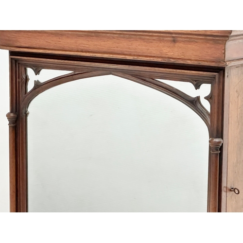 411 - A 19th Century Victorian oak Gothic style tabletop cabinet, with mirror panel door and fitted interi... 