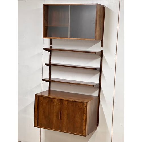 12A - Kai Kristensen. A Danish Mid Century rosewood wall modular shelving system. Designed by Kai Kristens... 