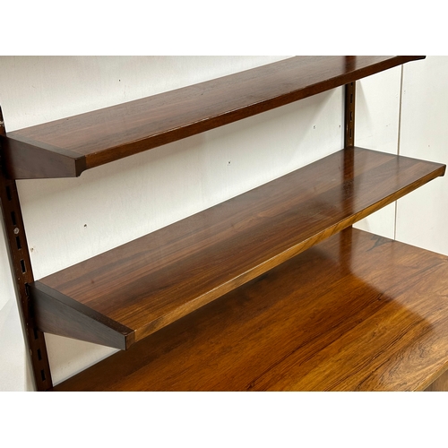 12A - Kai Kristensen. A Danish Mid Century rosewood wall modular shelving system. Designed by Kai Kristens... 