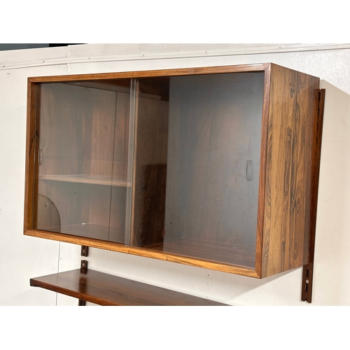 12A - Kai Kristensen. A Danish Mid Century rosewood wall modular shelving system. Designed by Kai Kristens... 