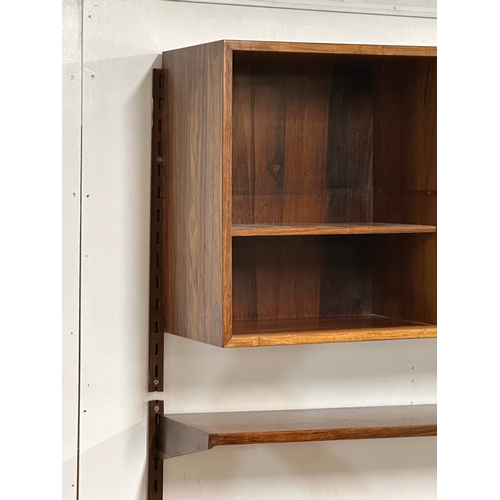 12A - Kai Kristensen. A Danish Mid Century rosewood wall modular shelving system. Designed by Kai Kristens... 